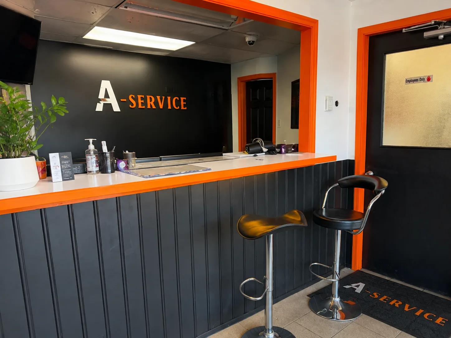 A-Service reception — near-black interior with orange trim